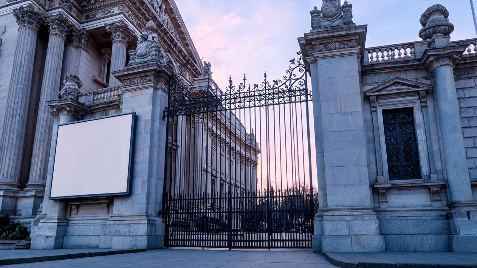 Museum entrance with a closed gate and a schedule board in early morning light